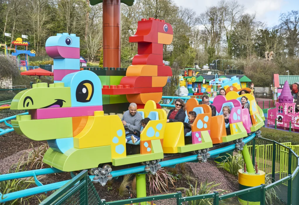Entrance of Legoland Windsor with giant LEGO models and families arriving.